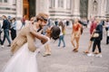 Multiethnic wedding couple. Wedding in Florence, Italy. African-American bride and Caucasian groom cuddling in Piazza