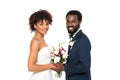 African american bride holding bouquet near bridegroom and looking at camera isolated on white Royalty Free Stock Photo