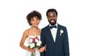 African american bride holding flowers near bridegroom looking at camera isolated on white Royalty Free Stock Photo