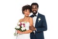 African american bride holding flowers near handsome bridegroom looking at camera isolated on white Royalty Free Stock Photo