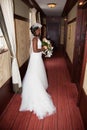 African american bride smiling at the camera holding bouquet Royalty Free Stock Photo