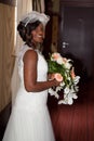 African american bride smiling at the camera holding bouquet Royalty Free Stock Photo