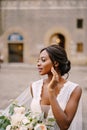 Wedding in Florence, Italy. African-American bride in a white dress and a long veil. With a magnificent bouquet of the