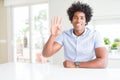 African American business man showing and pointing up with fingers number four while smiling confident and happy Royalty Free Stock Photo