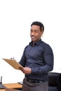 An African American Business Man standing and writing on a clipboard Royalty Free Stock Photo