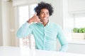 African American business man wearing elegant shirt smiling doing phone gesture with hand and fingers like talking on the Royalty Free Stock Photo