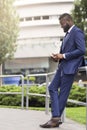 African american business person using mobile phone outdoors Royalty Free Stock Photo