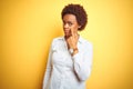 African american business woman over isolated yellow background Pointing to the eye watching you gesture, suspicious expression Royalty Free Stock Photo