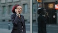 African american business woman speaking mobile phone go to office outdoors. Serious young afro girl businessperson Royalty Free Stock Photo