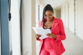 African american business woman standing, office hall with documents Royalty Free Stock Photo