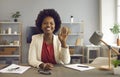 African american business woman waving in front of webcam welcoming online conference attendees.