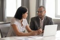 African American businessman and Asian businesswoman discussing project Royalty Free Stock Photo