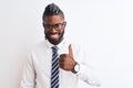 African american businessman with braids wearing tie glasses over isolated white background doing happy thumbs up gesture with Royalty Free Stock Photo