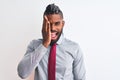 African american businessman with braids wearing tie standing over isolated white background covering one eye with hand, confident Royalty Free Stock Photo