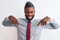 African american businessman with braids wearing tie standing over isolated white background looking confident with smile on face, Royalty Free Stock Photo