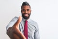 African american businessman with braids wearing tie standing over isolated white background smiling friendly offering handshake Royalty Free Stock Photo