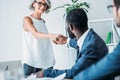 african american businessman and caucasian businesswoman shaking hands Royalty Free Stock Photo