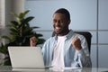 African american businessman celebrating business success achievement, shouting. Royalty Free Stock Photo