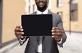 African american businessman demonstrating tablet with blank screen, demonstrating space for your ad, mockup Royalty Free Stock Photo