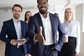 African American businessman greeting job candidate into team Royalty Free Stock Photo