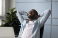 African american businessman with hands behind head relaxing.