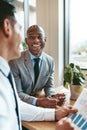 African American businessman laughing with a colleague in an off Royalty Free Stock Photo