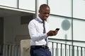 African american businessman looking at mobile phone in the city Royalty Free Stock Photo