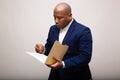 African American Businessman Looks Through Folder