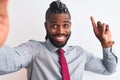 African american businessman make selfie by camera over isolated white background surprised with an idea or question pointing Royalty Free Stock Photo