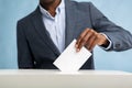 African american businessman pulling decision on paper in vote ballot