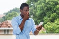 African american businessman receiving text message with bad new
