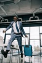 African american businessman running for flight at airport Royalty Free Stock Photo