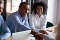 African American businessman shaking hand of business partner at meeting