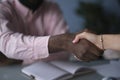 African American businessman shaking hands with caucasian businesswoman. Close up of African American man shaking hand Royalty Free Stock Photo