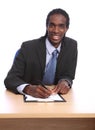 African American businessman signing document Royalty Free Stock Photo
