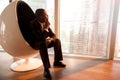 African-american businessman sitting in egg chair enjoying sunse Royalty Free Stock Photo