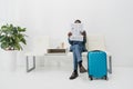 African american Businessman sitting in waiting room and reading Royalty Free Stock Photo