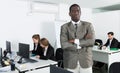 African American businessman standing at office near colleagues Royalty Free Stock Photo