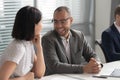 African American businessman talking with colleague, laughing at joke Royalty Free Stock Photo