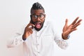 African american businessman talking on smartphone over isolated white background very happy and excited, winner expression Royalty Free Stock Photo