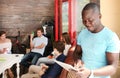 African American businessman is using a digital tablet and smiling while sitting in his office. Royalty Free Stock Photo