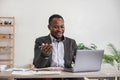 African American businessman using his laptop computer while working remotely from home. Online working or learning Royalty Free Stock Photo