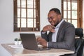 African American businessman using his laptop computer while working remotely from home. Online working or learning Royalty Free Stock Photo