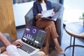 African american businessman using laptop and caucasian female colleague sitting on chair in office Royalty Free Stock Photo