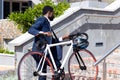African american businessman wearing suit holding bicycle on stairs Royalty Free Stock Photo