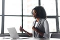 The African-American businesswoman beams with a headset on, engaging in a cheerful conversation Royalty Free Stock Photo