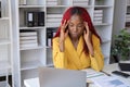 African American businesswoman has fatigue and headaches from working in the office. Royalty Free Stock Photo