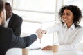 African American businesswoman shake hand of colleague at briefing