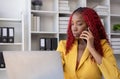 African American businesswoman talking on the phone while working in the office with stress Royalty Free Stock Photo