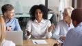 African businesswoman talking to clients making offer at group negotiation Royalty Free Stock Photo